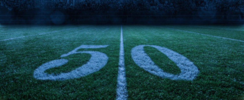 Photo of the 50-yard line on a football field.